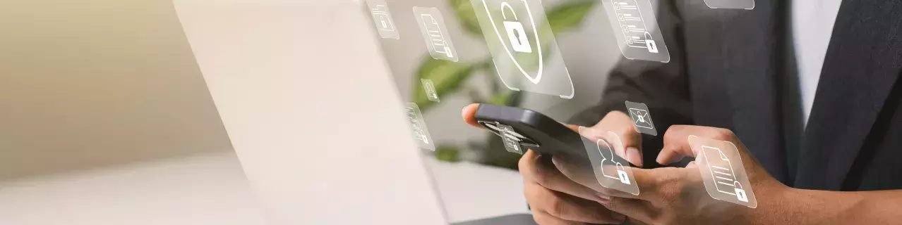 A person with a laptop and lock icons floating above it.