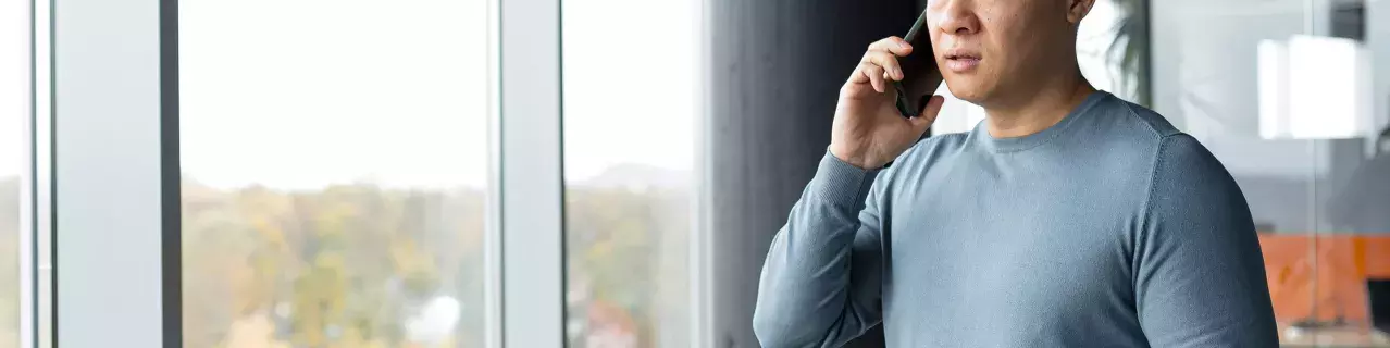 A person on a phone call looking concerned