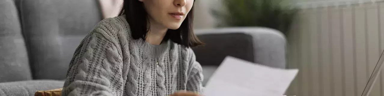 A person looking at a bill inquisitively