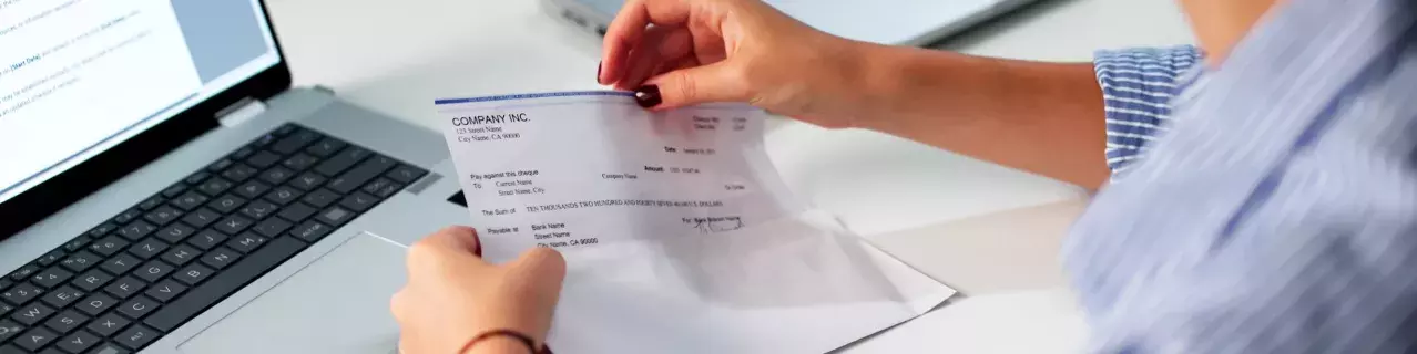 A person looking at a paycheck