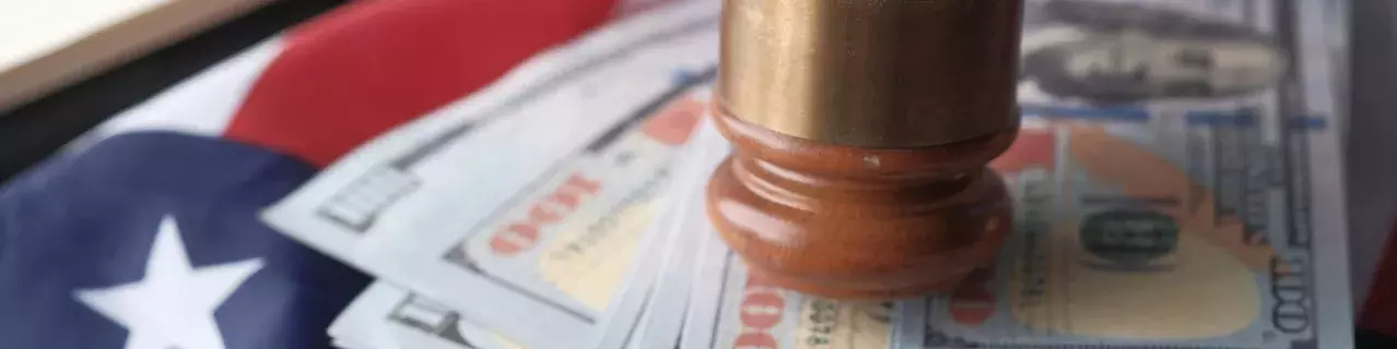 A gavel on top of U.S. currency