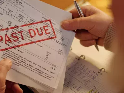 A person looking at past-due bills.