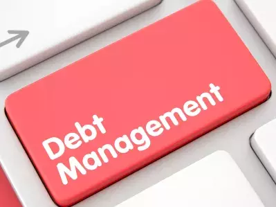 A keyboard with a "Debt Management" button.