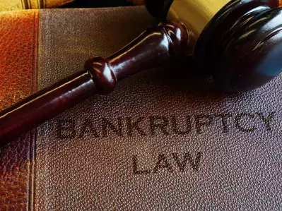 A bankruptcy book with a gavel on top of it