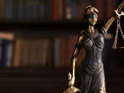 A small sculpture of lady justice holding scales and a sword