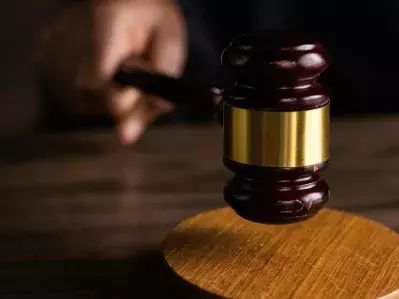 A judge striking a gavel in a courtroom.
