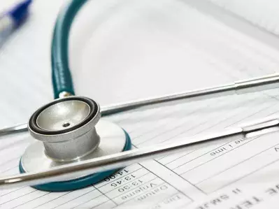 A photo of a stethoscope on top of medical paperwork