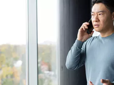 A person on a phone call looking concerned
