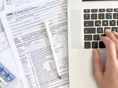 A person using a computer to do their taxes