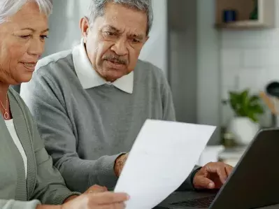 People looking at a letter inquisitively