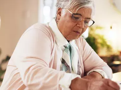 A person writing a letter