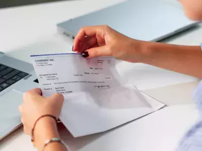 A person looking at a paycheck