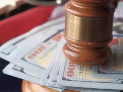 A gavel on top of U.S. currency