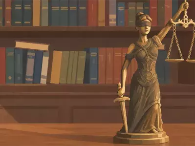 Lady Justice statue with scales and law books