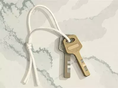 Pair of keys tied with string on marble