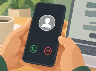 Hands holding phone with incoming call on desk