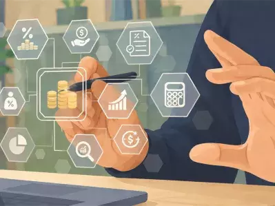 Businessperson using tablet beside laptop