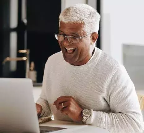 Man working on computer and smiling